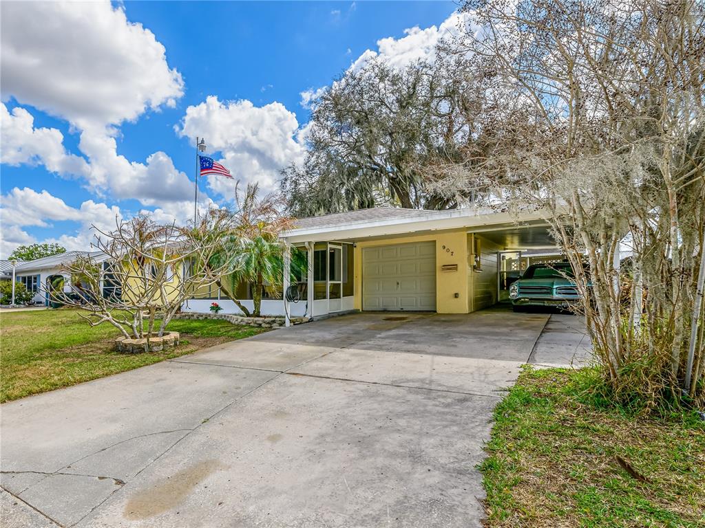 907 Hillside Terrace Brandon, FL 33511 - Photo 32 of 35 a view of a house with a yard and garage