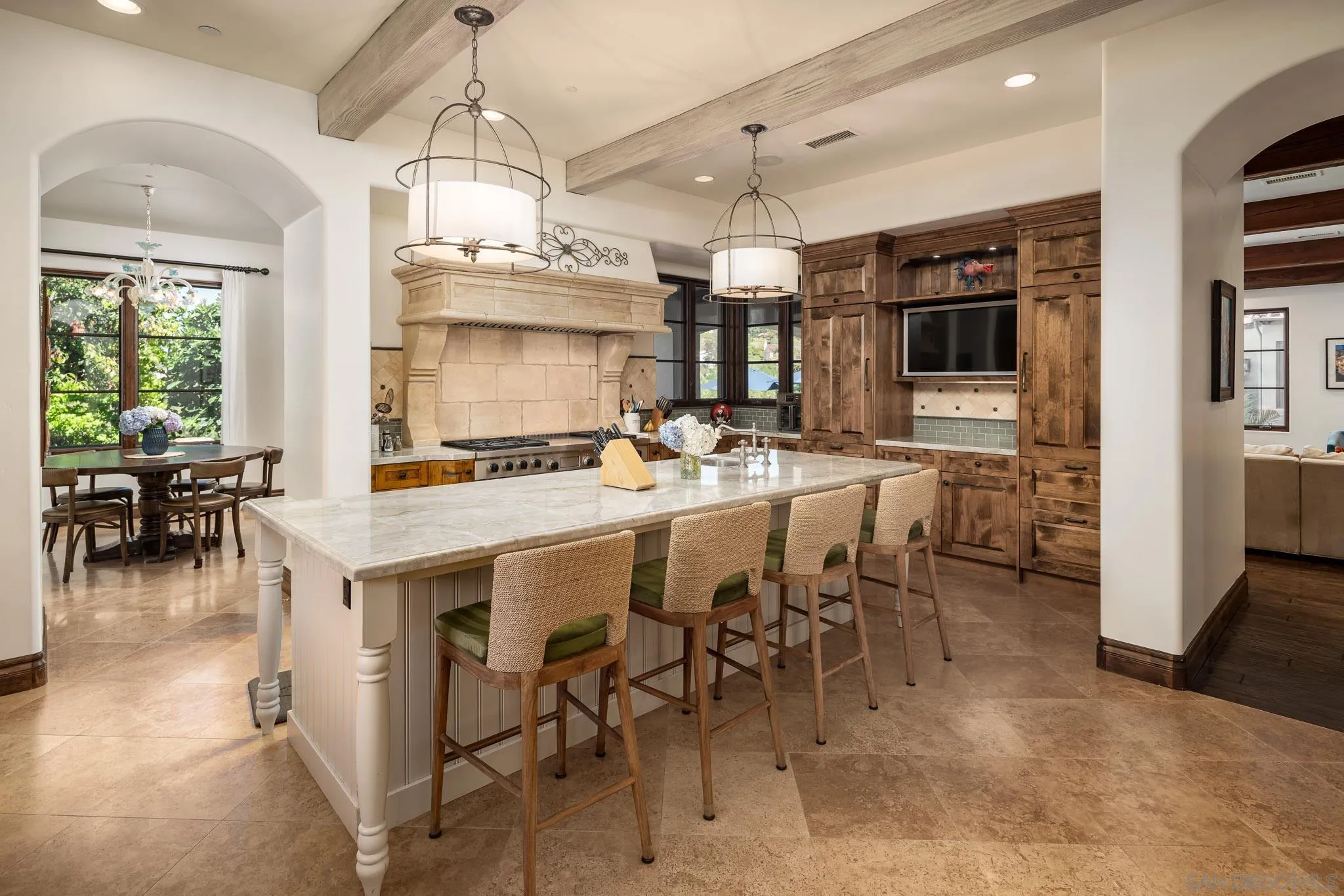 8053 High Time Ridge San Diego, CA 92127 - Photo 18 of 62 a kitchen with a table chairs refrigerator and cabinets