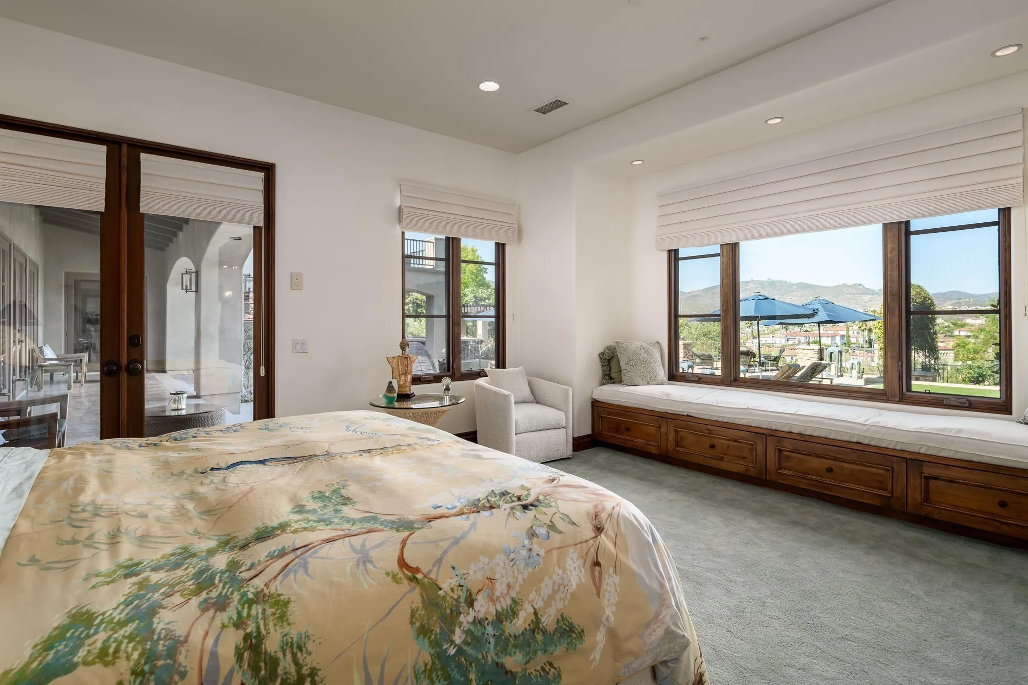 8053 High Time Ridge San Diego, CA 92127 - Photo 25 of 62 a spacious bedroom with a bed and large windows