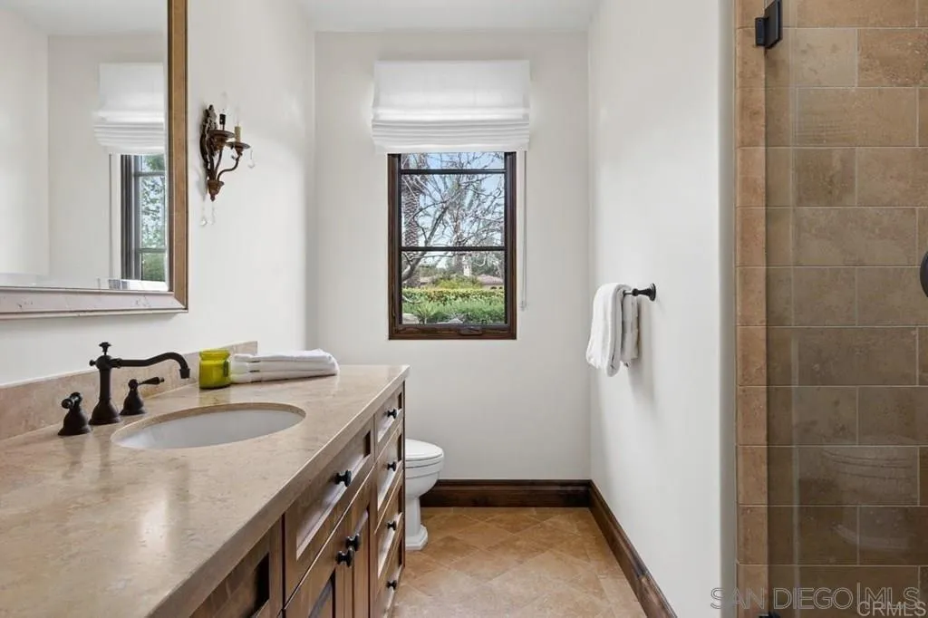 8053 High Time Ridge San Diego, CA 92127 - Photo 37 of 62 a bathroom with a sink a window and a mirror