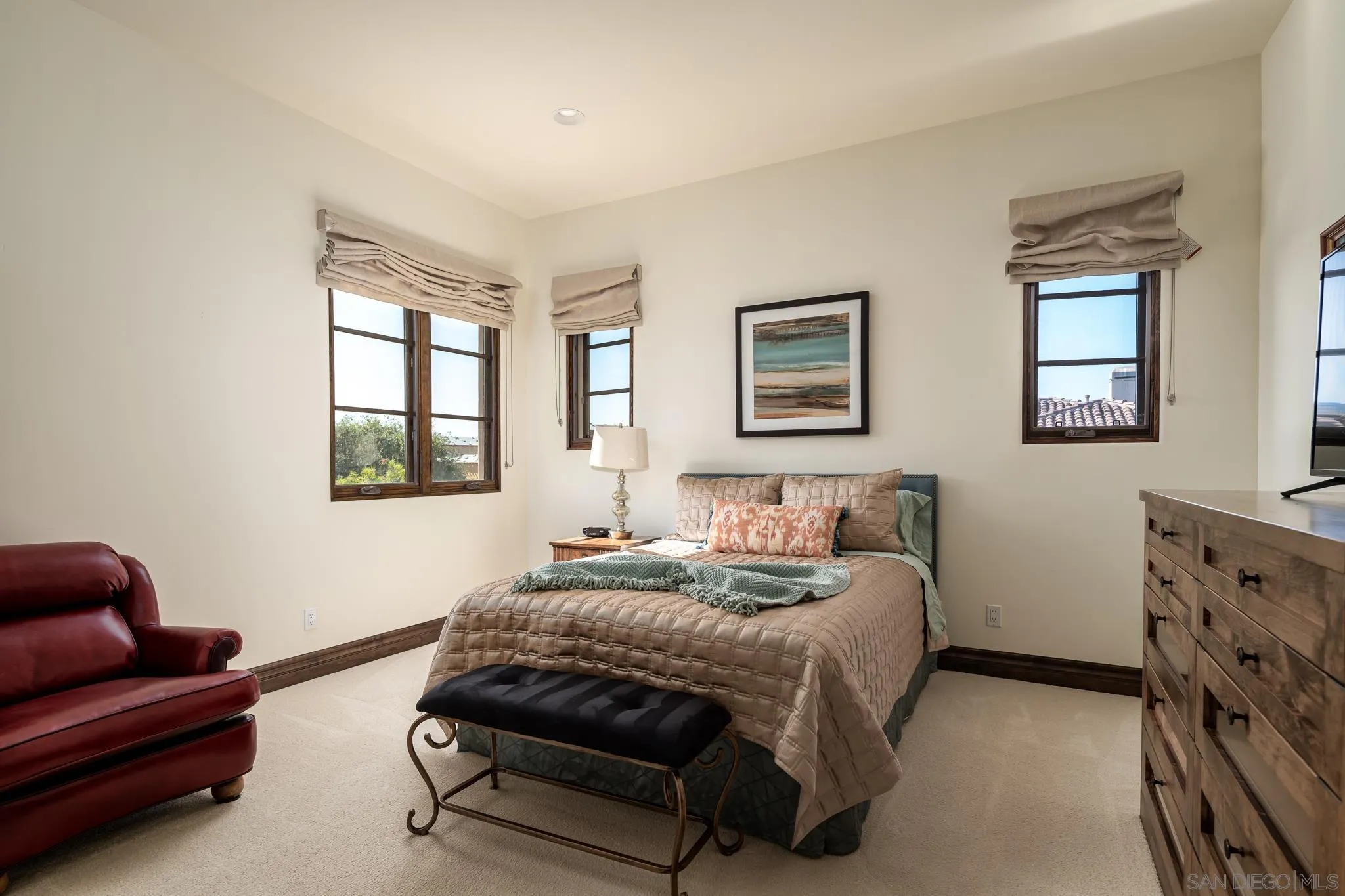 8053 High Time Ridge San Diego, CA 92127 - Photo 39 of 62 a spacious bedroom with a bed a couch and windows