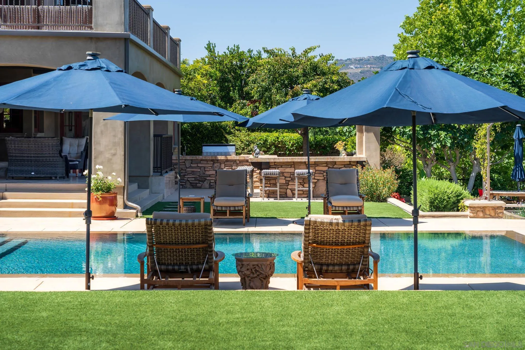 8053 High Time Ridge San Diego, CA 92127 - Photo 50 of 62 a patio with table and chairs under an umbrella