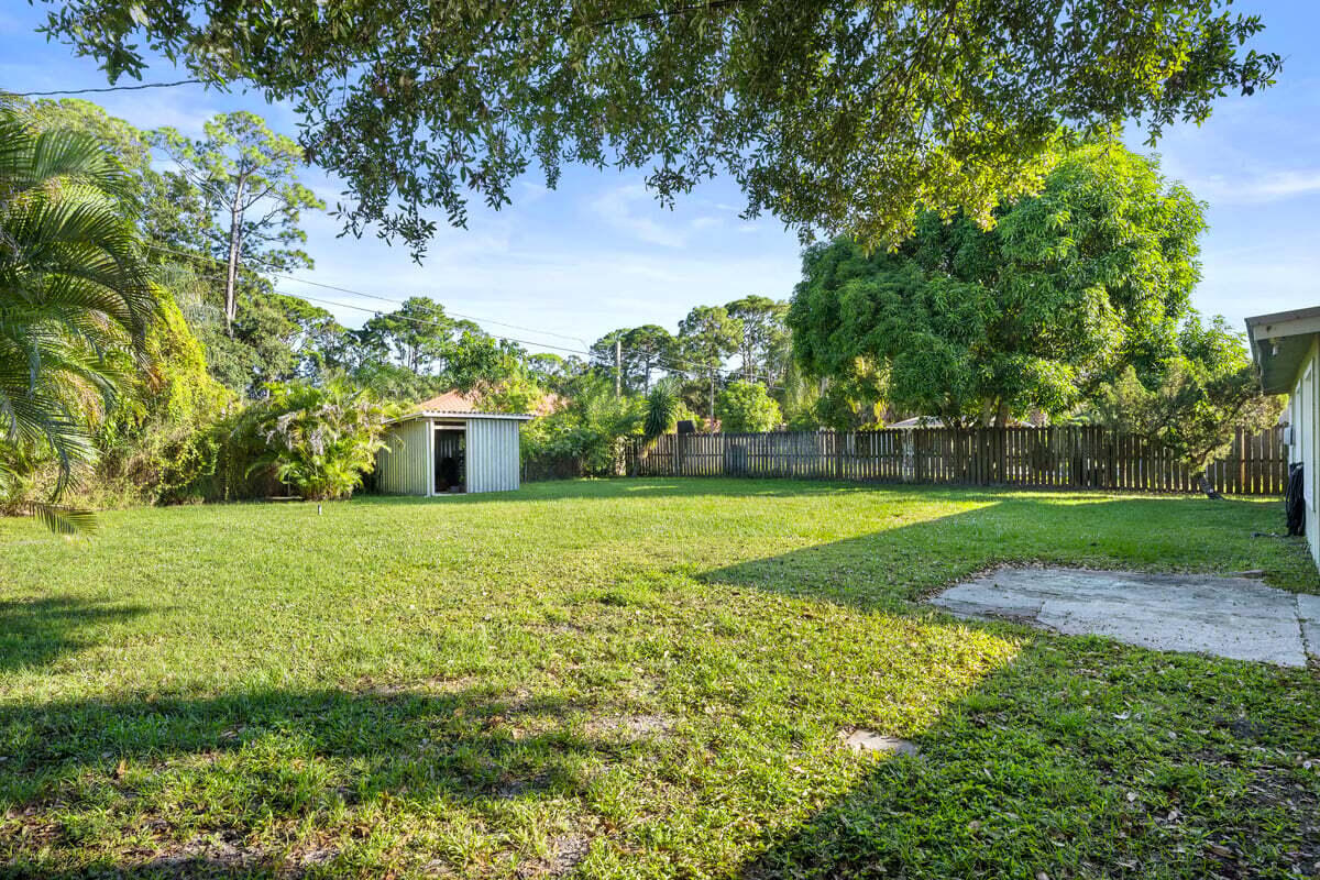 1875 45th Avenue Vero Beach, FL 32966 - Photo 13 of 14 a view of a garden with large trees
