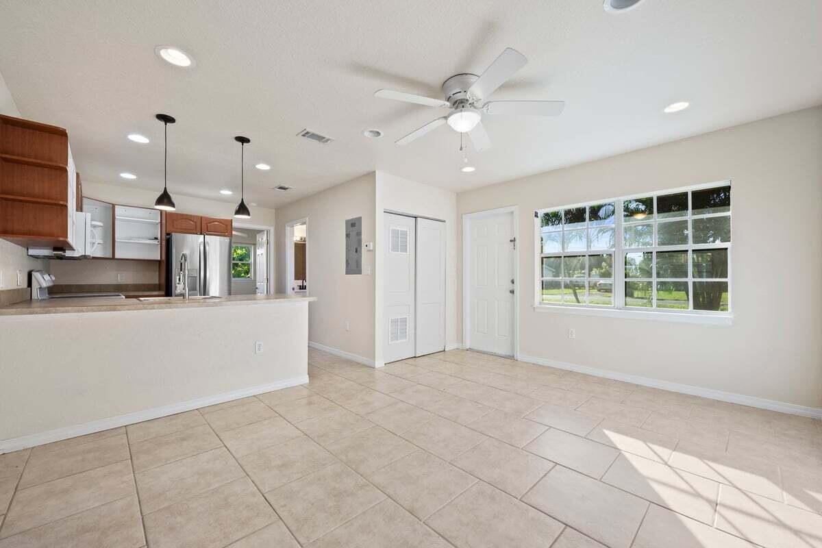 1875 45th Avenue Vero Beach, FL 32966 - Photo 4 of 14 a view of an empty room with kitchen view and a window