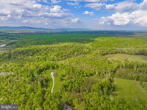 a view of yard with swimming pool and green space
