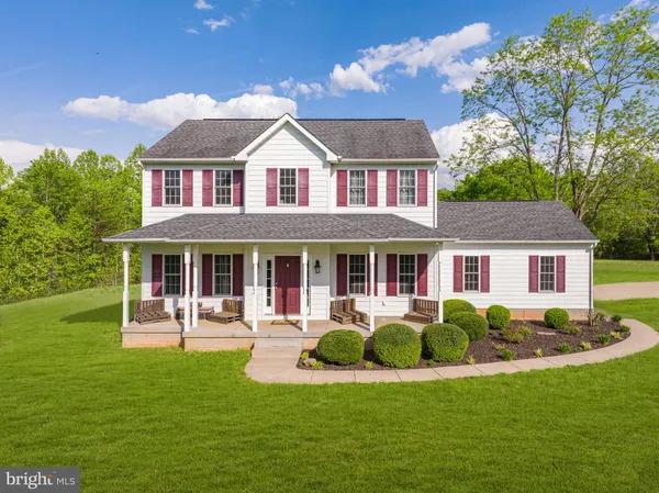a front view of a house with a yard table and chairs