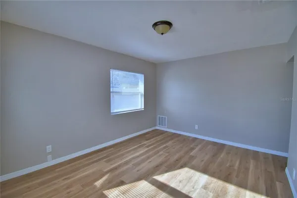 a view of wooden floor and windows in a room