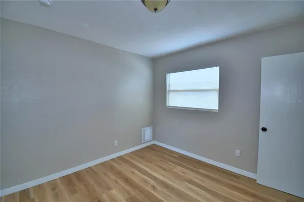 a view of wooden floor and windows in a room