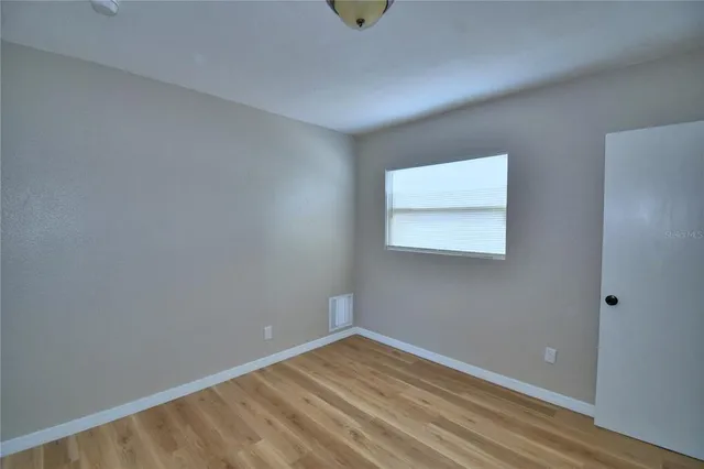 a view of wooden floor and windows in a room