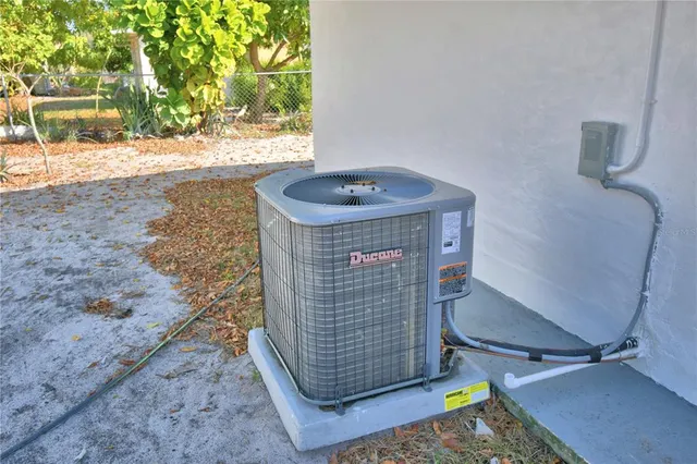 a view of a house with a backyard and a tree