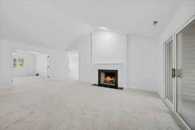 a view of an empty room with a fireplace