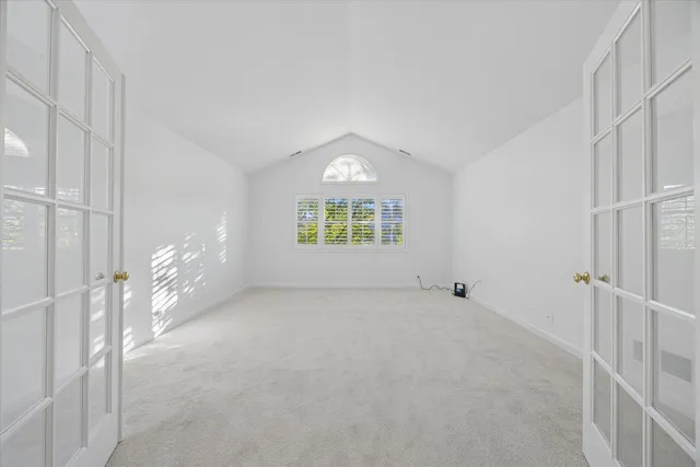 a view of an empty room and a window