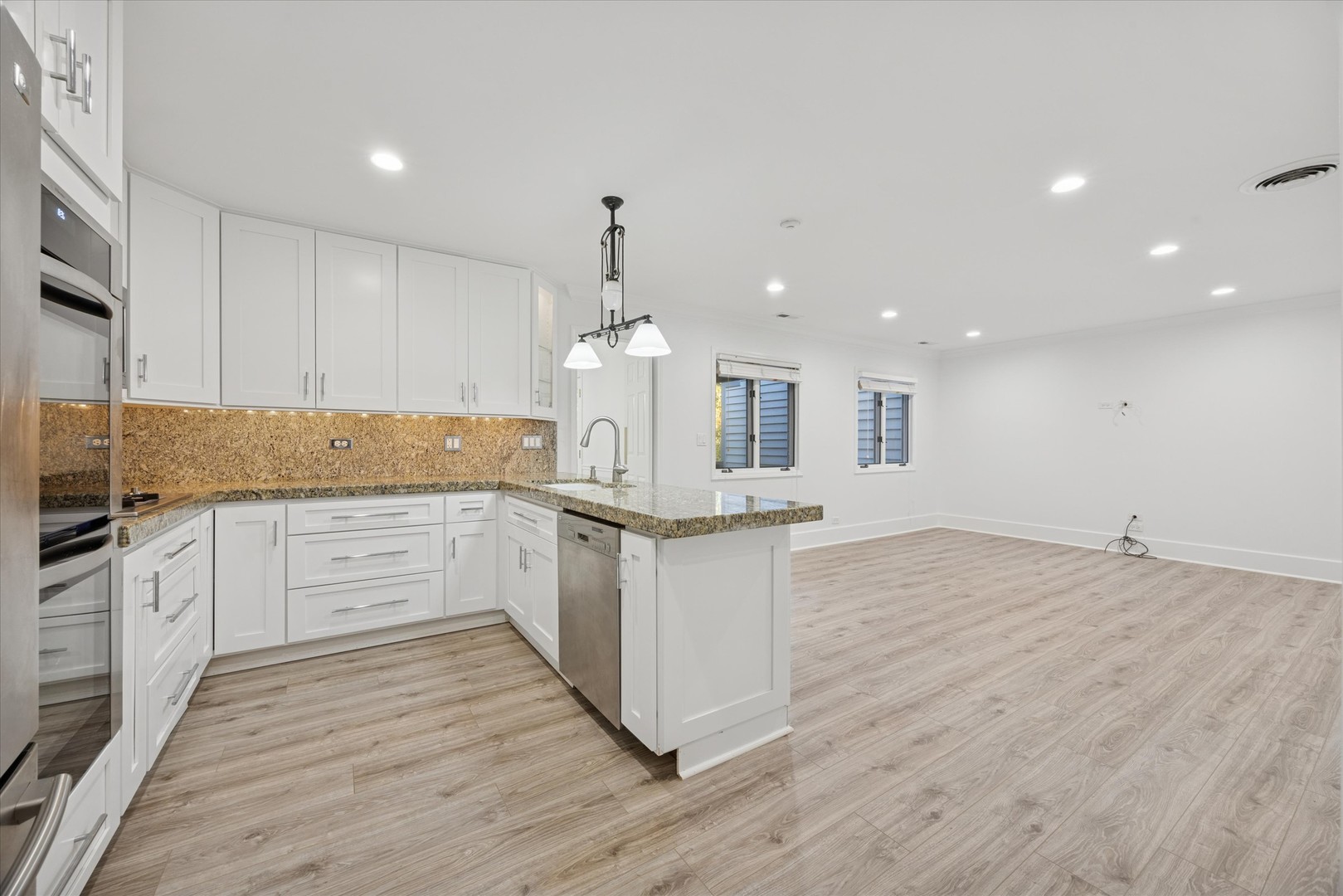 179 Foxborough Place Burr Ridge, IL 60527 - Photo 6 of 18 a large kitchen with granite countertop a large counter top stainless steel appliances and cabinets
