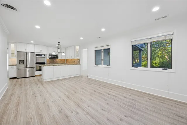 a view of kitchen with wooden floor and window