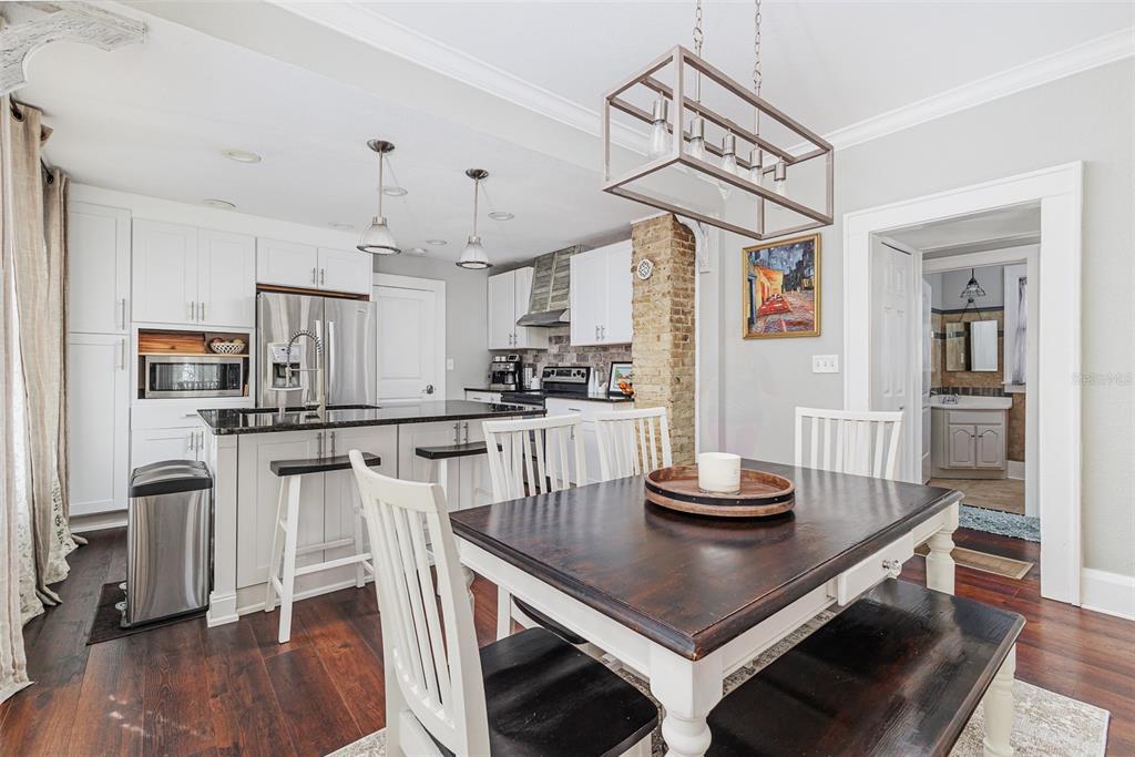 749 South Rushing Avenue Lakeland, FL 33801 - Photo 15 of 45 a kitchen with stainless steel appliances kitchen island granite countertop a table and chairs in it