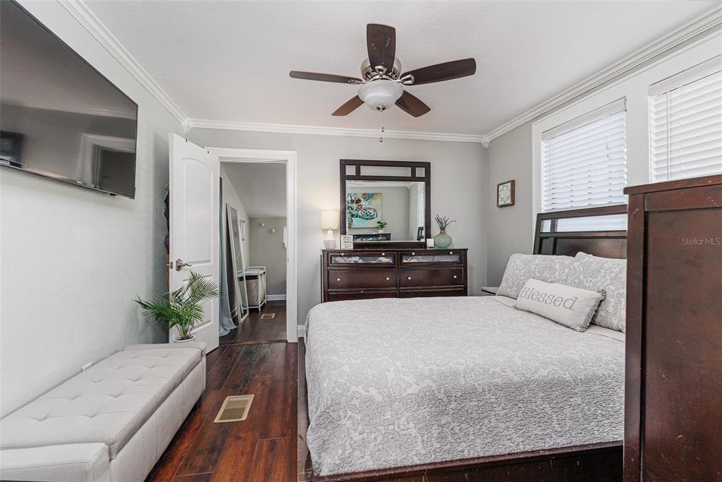 749 South Rushing Avenue Lakeland, FL 33801 - Photo 16 of 45 a bedroom with a large bed and a chandelier