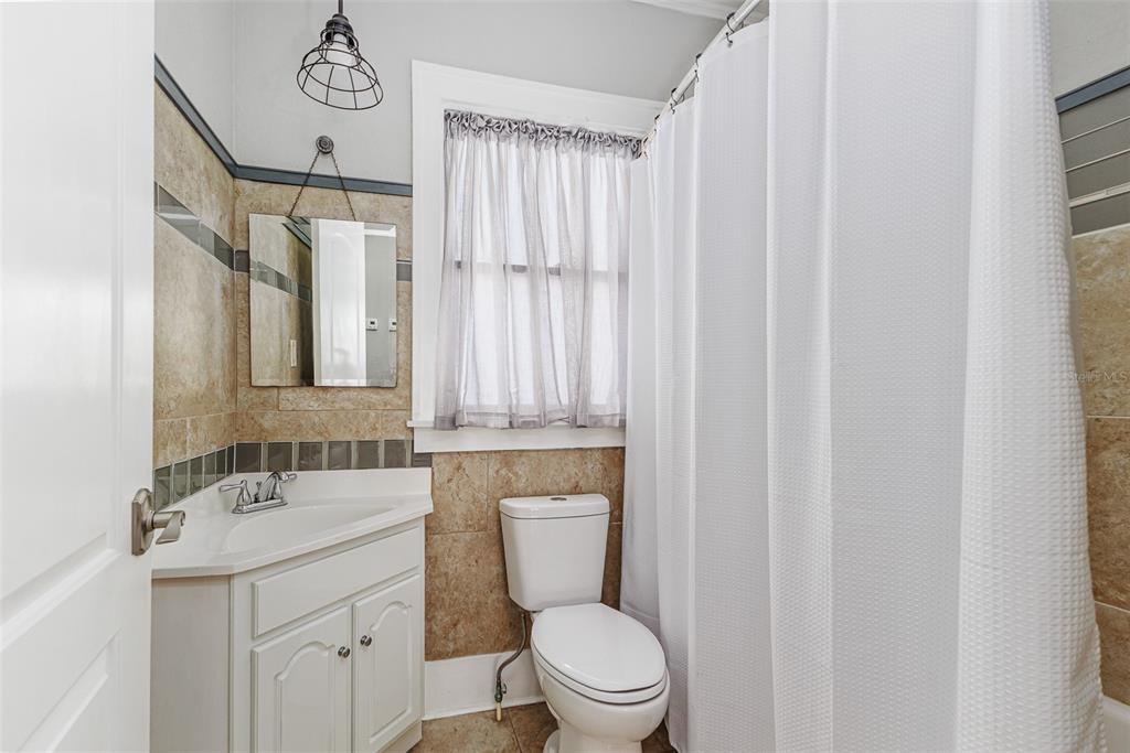 749 South Rushing Avenue Lakeland, FL 33801 - Photo 23 of 45 a bathroom with a toilet a sink and a mirror