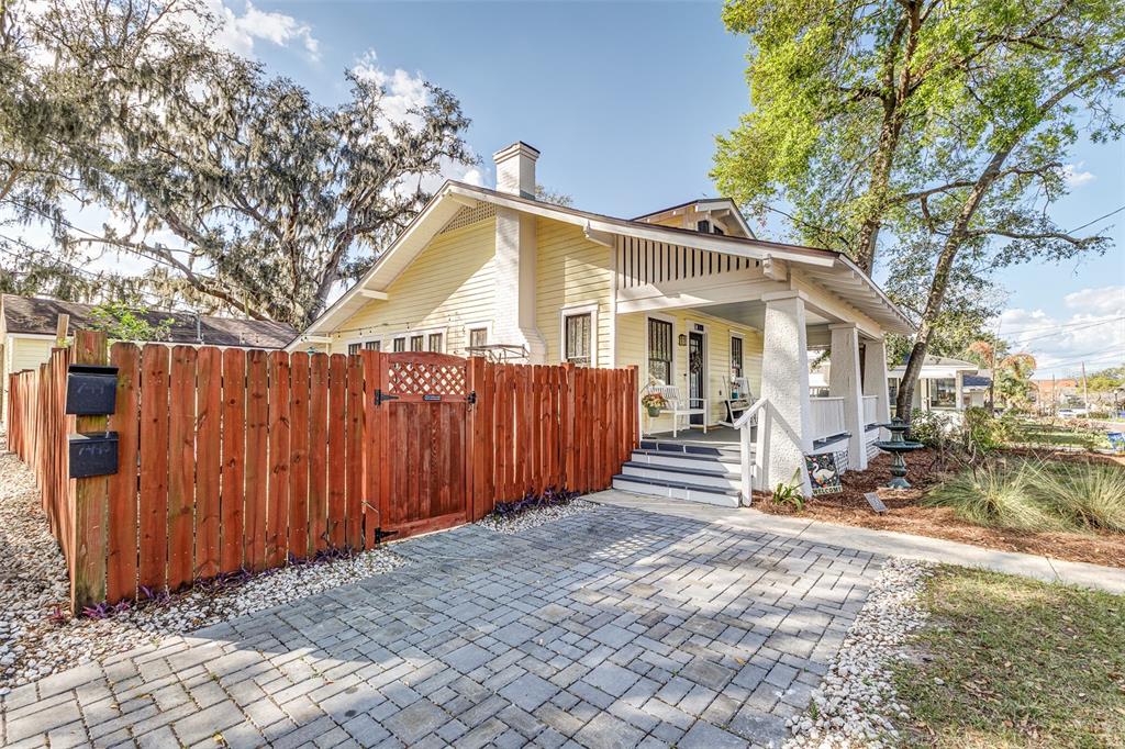 749 South Rushing Avenue Lakeland, FL 33801 - Photo 3 of 45 a view of a house with a large tree and wooden fence