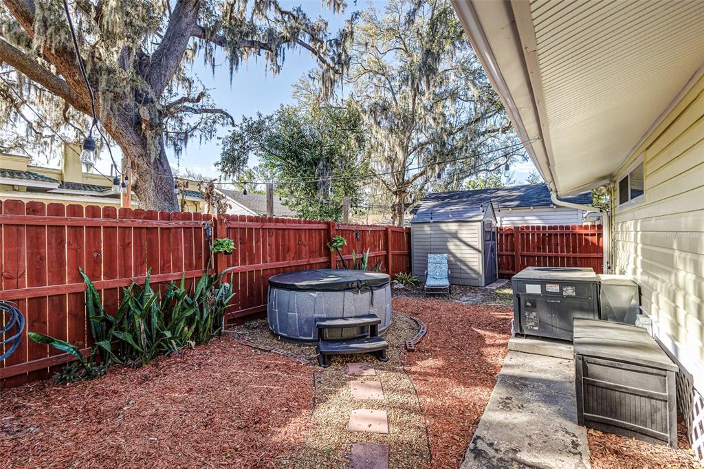 749 South Rushing Avenue Lakeland, FL 33801 - Photo 41 of 45 a backyard of a house with barbeque oven and a tree