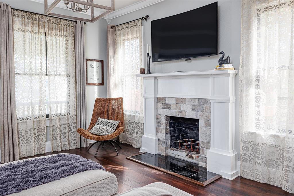 749 South Rushing Avenue Lakeland, FL 33801 - Photo 7 of 45 a living room with a fireplace and a flat screen tv