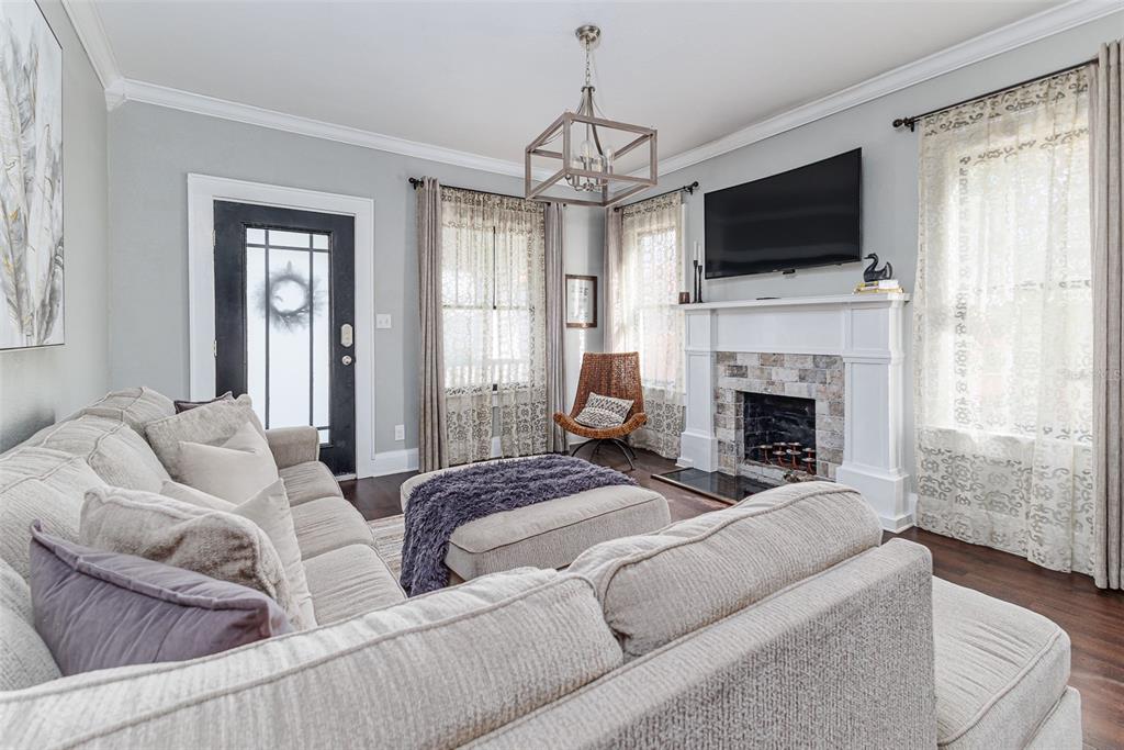 749 South Rushing Avenue Lakeland, FL 33801 - Photo 8 of 45 a living room with furniture a fireplace and a flat screen tv