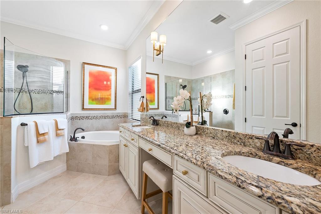 2806 Aviamar Circle Naples, FL 34114 - Photo 11 of 50 a bathroom with a granite countertop double vanity sink a bathtub and mirror