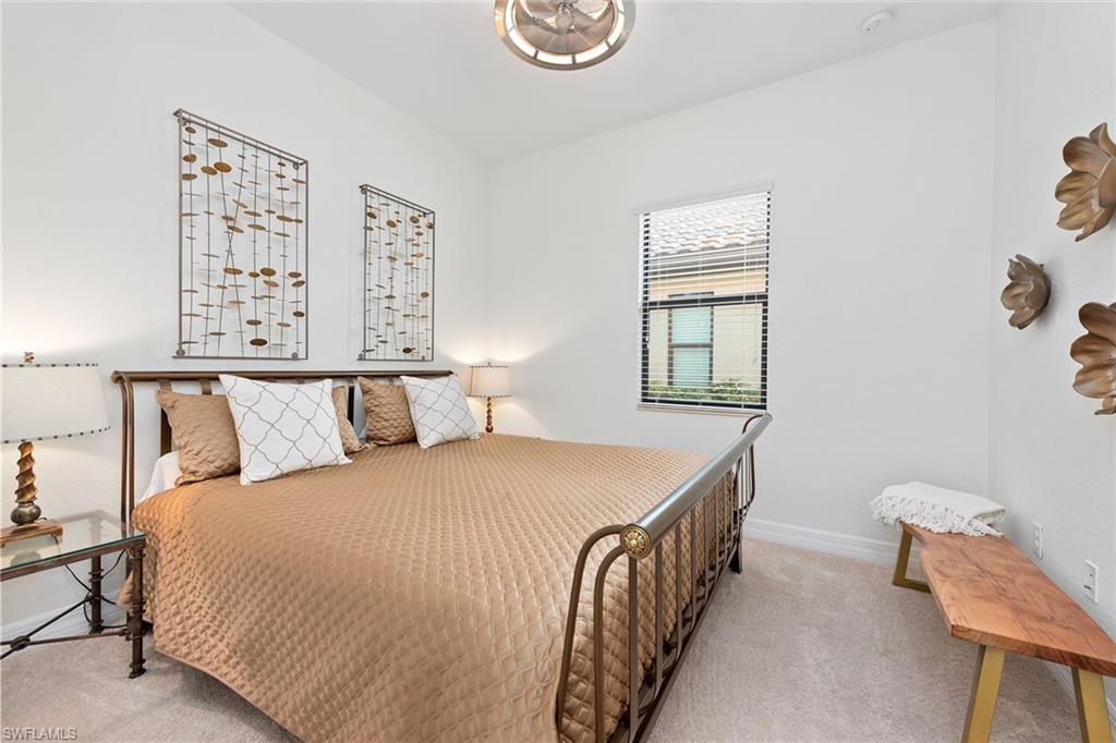 2806 Aviamar Circle Naples, FL 34114 - Photo 15 of 50 a bedroom with a bed and a chair