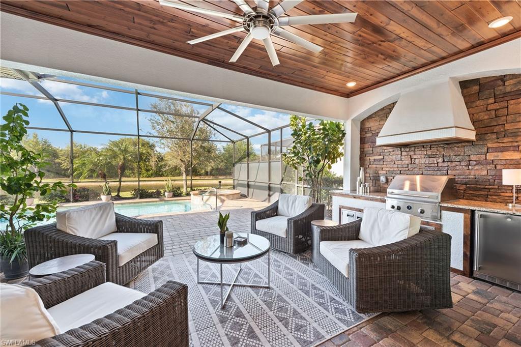2806 Aviamar Circle Naples, FL 34114 - Photo 21 of 50 a living room with furniture and a large window