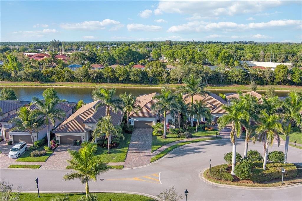 2806 Aviamar Circle Naples, FL 34114 - Photo 34 of 50 a view of a swimming pool with a table and chairs