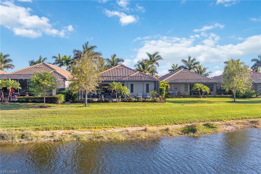 2806 Aviamar Circle Naples, FL 34114 - Photo 37 of 50 a front view of a house with a big yard