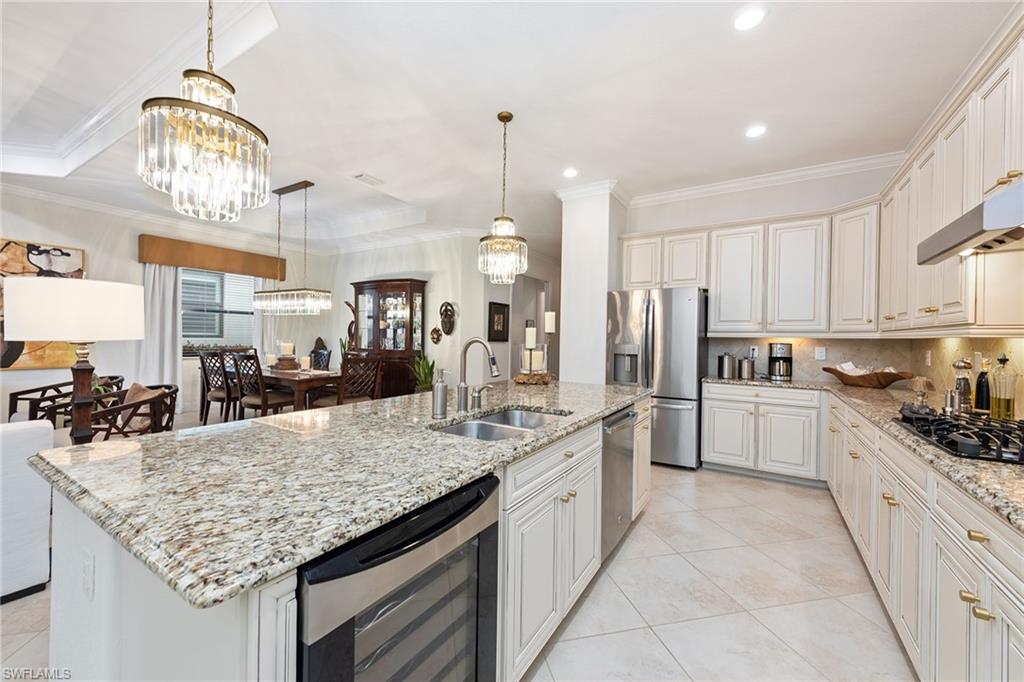2806 Aviamar Circle Naples, FL 34114 - Photo 6 of 50 a kitchen with stainless steel appliances granite countertop stove top oven and refrigerator
