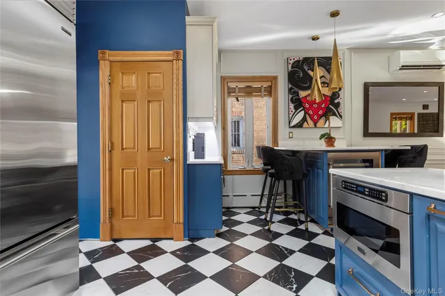 a kitchen with stainless steel appliances kitchen island granite countertop a stove and a sink