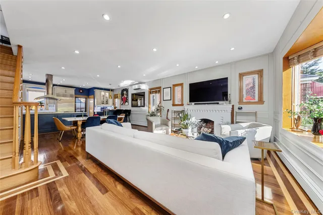 a living room with fireplace furniture and a flat screen tv