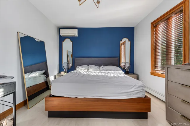 a bedroom with a bed and a mirror