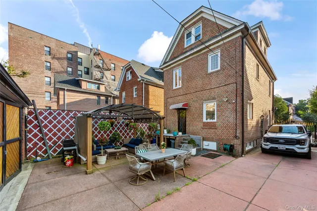 a view of a patio with a table and chairs under an umbrella