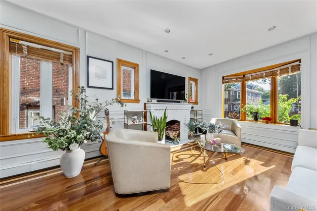a living room with fireplace furniture and a flat screen tv