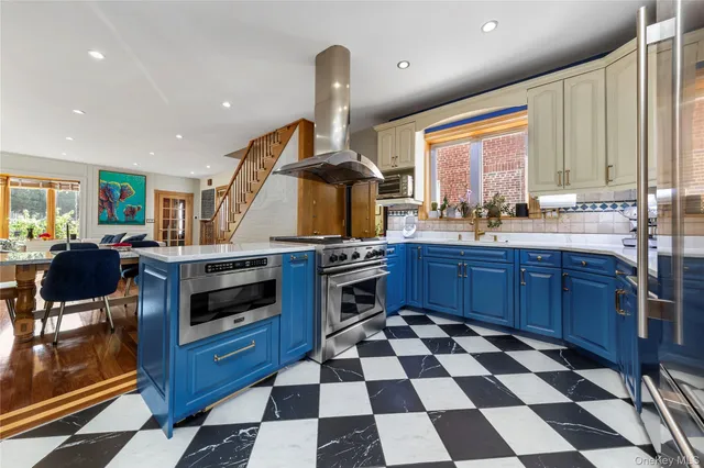 a kitchen with stainless steel appliances a stove a sink a counter top space and cabinets