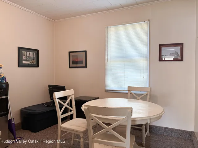 a dining room with furniture and a window