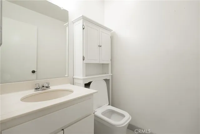 a bathroom with a sink toilet and vanity