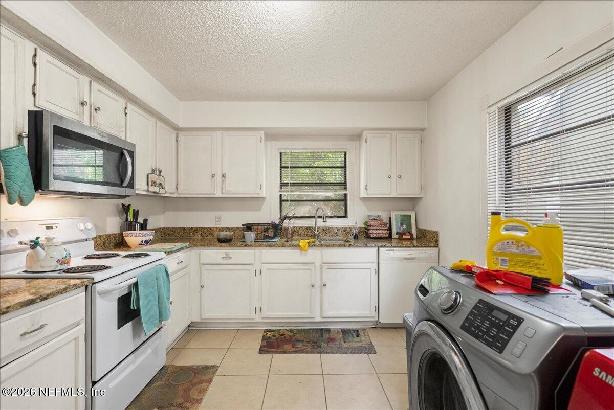2910 Post Street Jacksonville, FL 32205 - Photo 21 of 34 a kitchen with a sink stove top oven and microwave