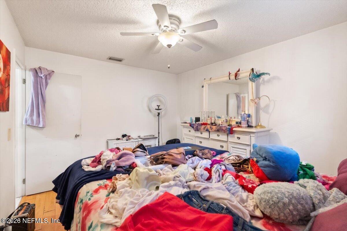2910 Post Street Jacksonville, FL 32205 - Photo 26 of 34 a bed room with a bed a couch and a chandelier