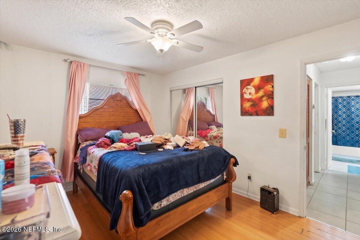 2910 Post Street Jacksonville, FL 32205 - Photo 27 of 34 a bedroom with a bed and a chandelier