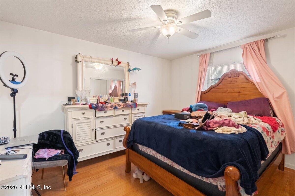 2910 Post Street Jacksonville, FL 32205 - Photo 28 of 34 a bedroom with a bed and a chandelier