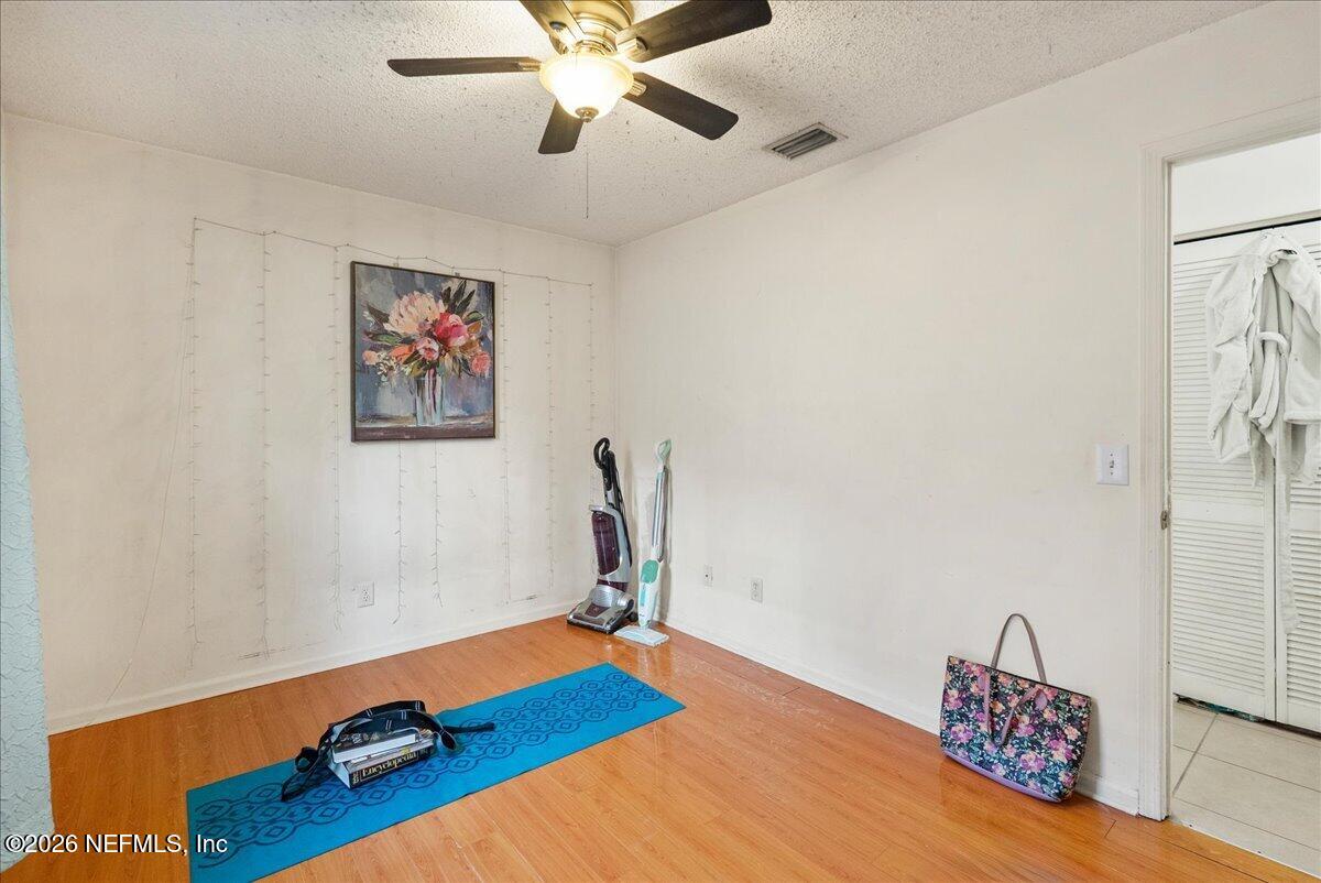 2910 Post Street Jacksonville, FL 32205 - Photo 29 of 34 a room with a bed and a chandelier