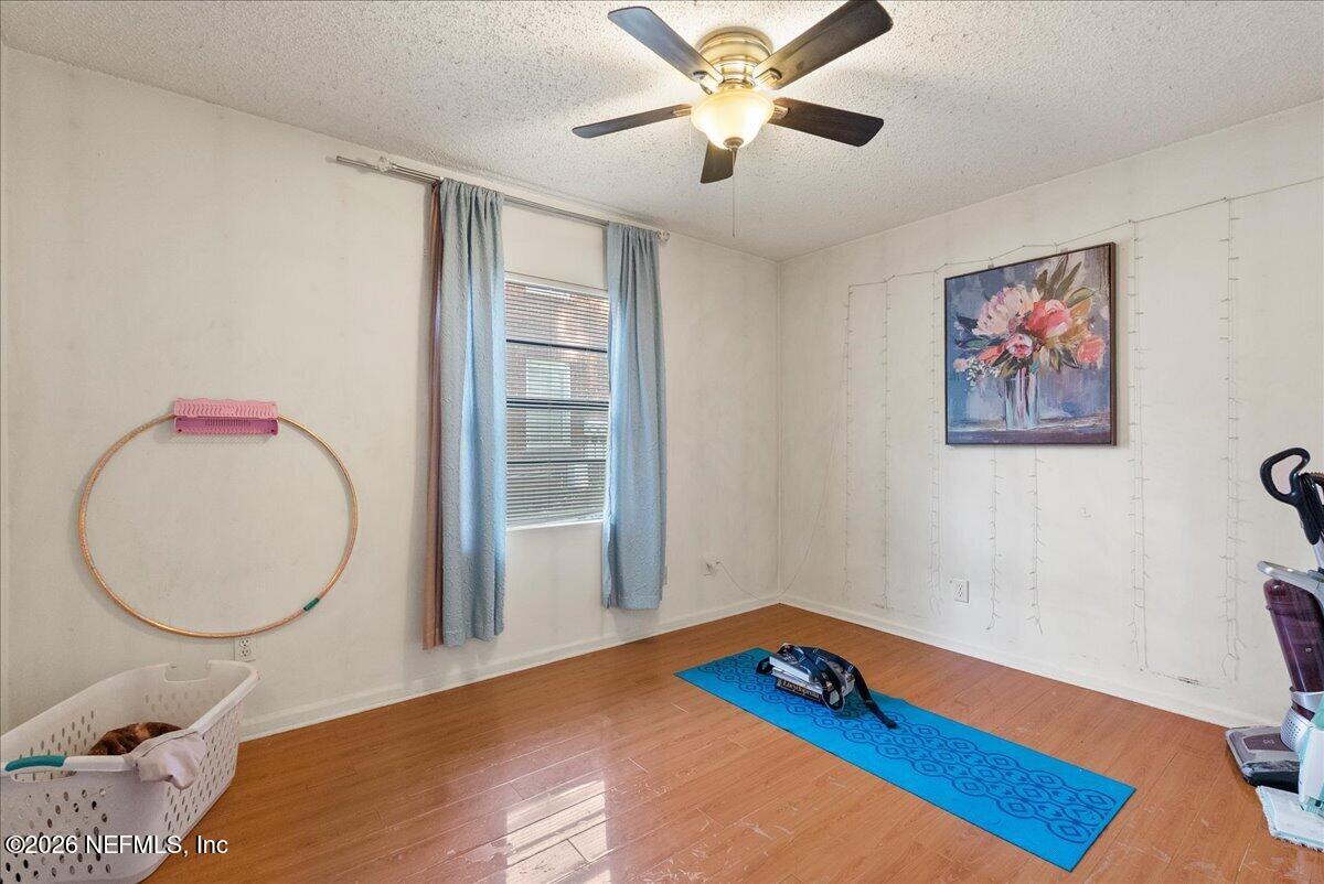 2910 Post Street Jacksonville, FL 32205 - Photo 32 of 34 a bedroom with a bed and a chandelier