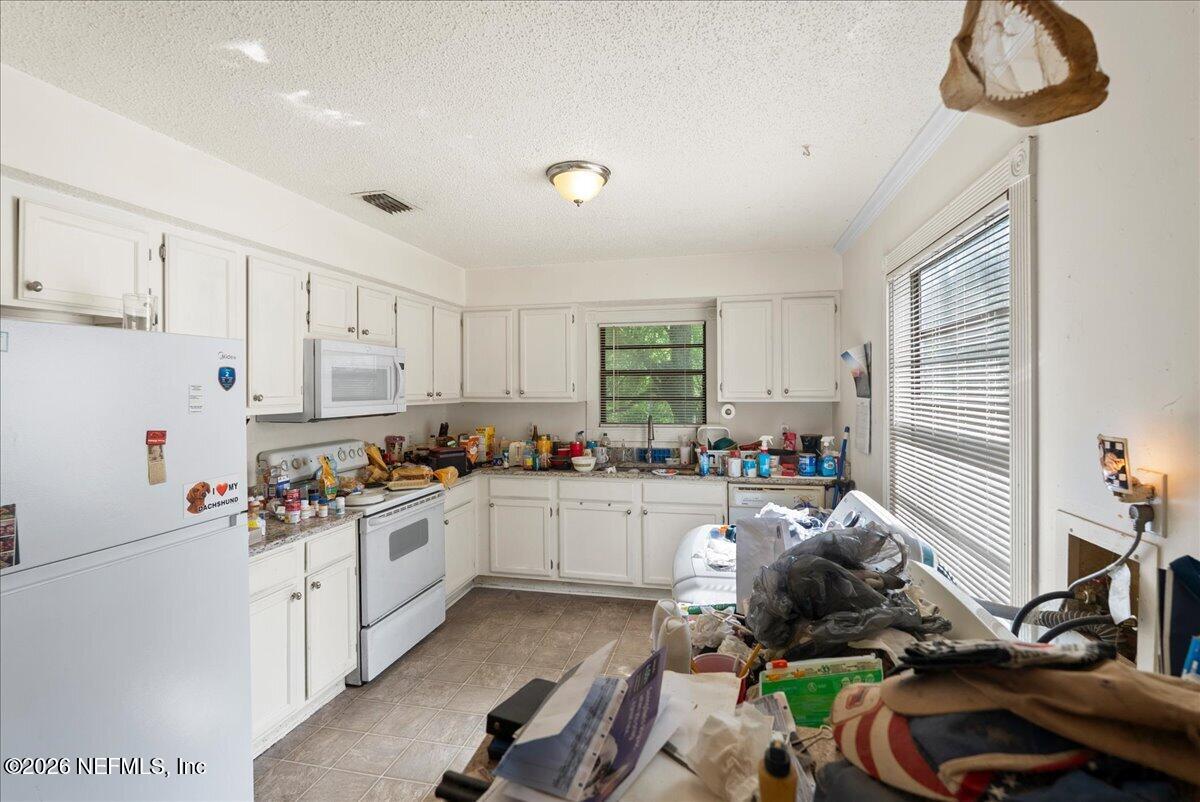2910 Post Street Jacksonville, FL 32205 - Photo 9 of 34 a kitchen that has a lot of cabinets a sink and appliances