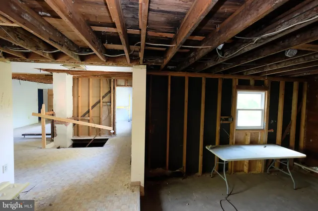 a view of hallway with couch and a window