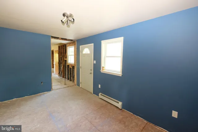 an empty room with windows and closet