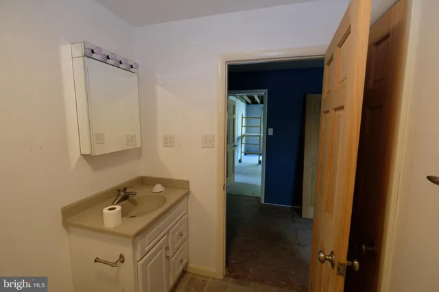 a view of an empty room with a fireplace