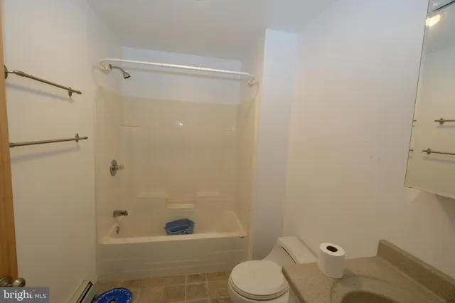 a view of a bathroom with a shower and a door